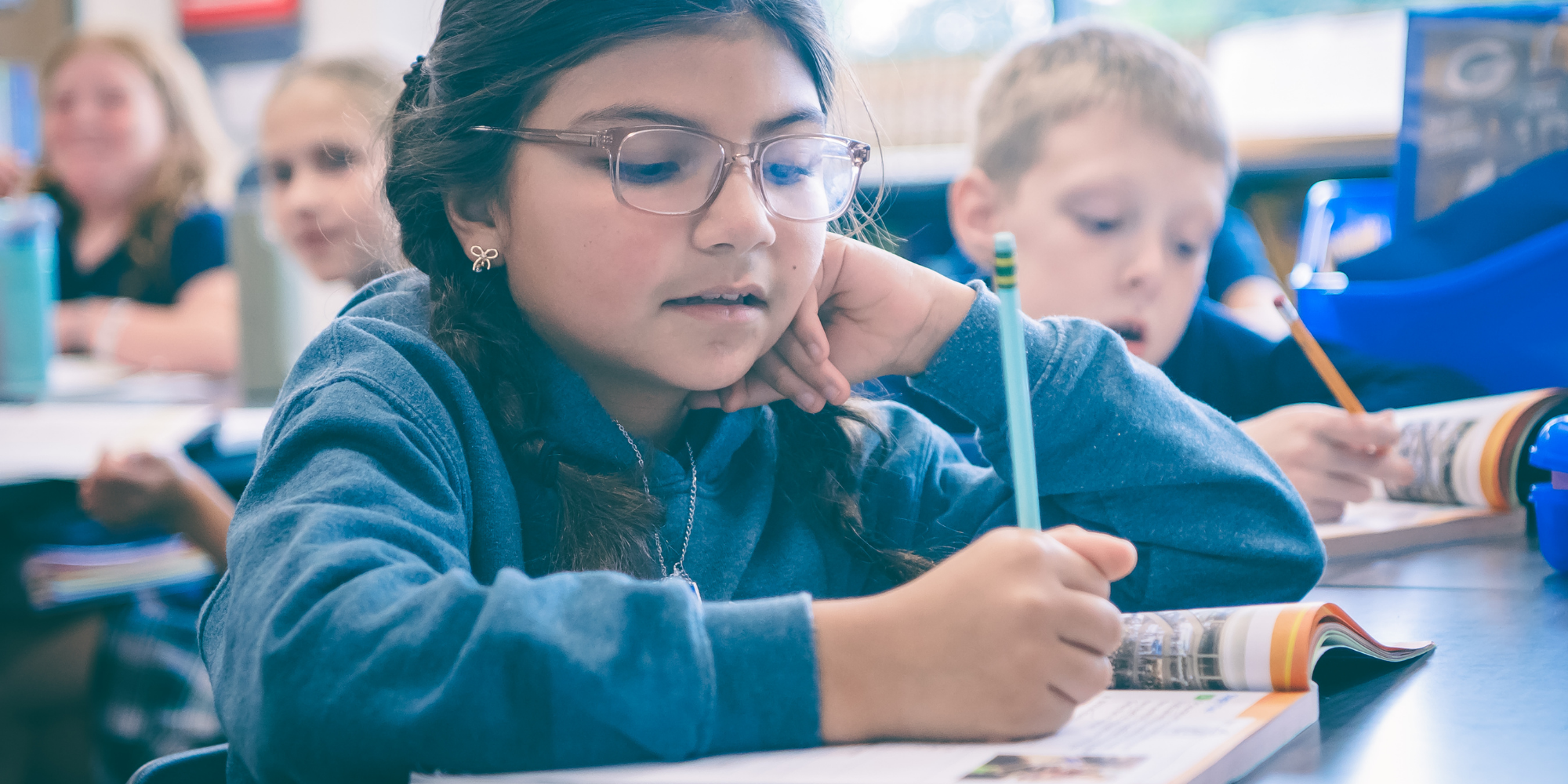 NDDP student writing in workbook