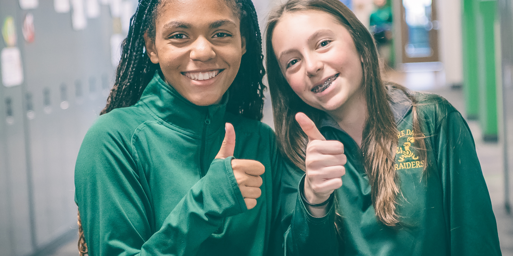 Two NDDP students giving thumbs up