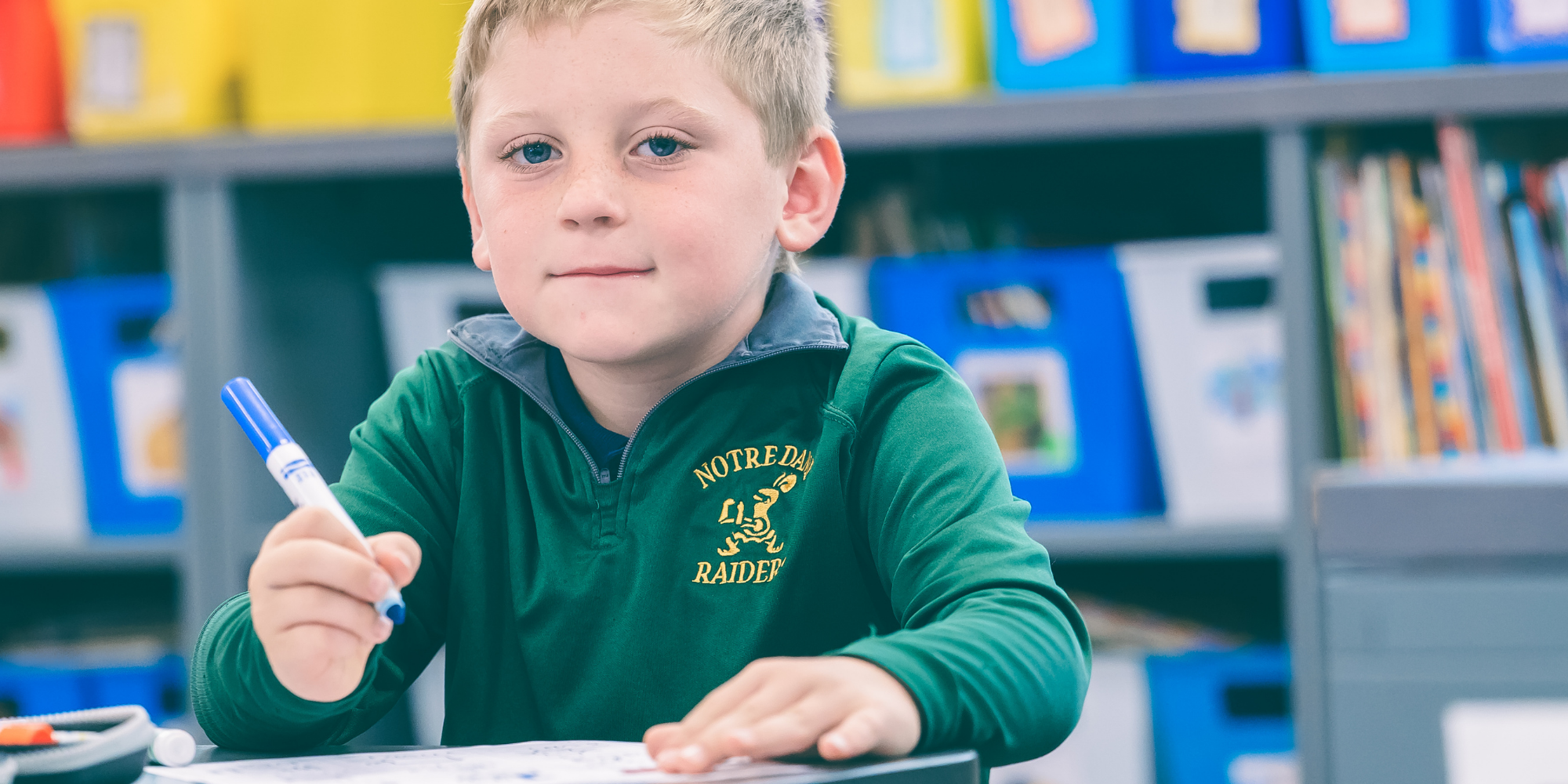 NDDP student with marker in classroom
